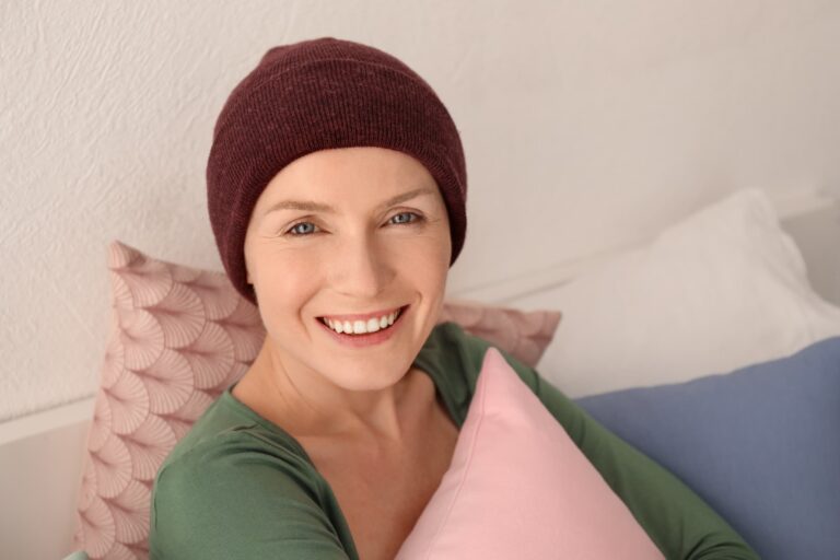 Smiling Woman Wearing Chemo Hat